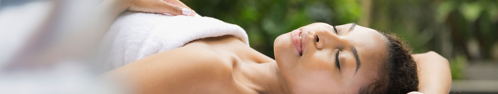 Woman wrapped in spa towel resting at The Residences at The St. Regis Longboat Key Resort