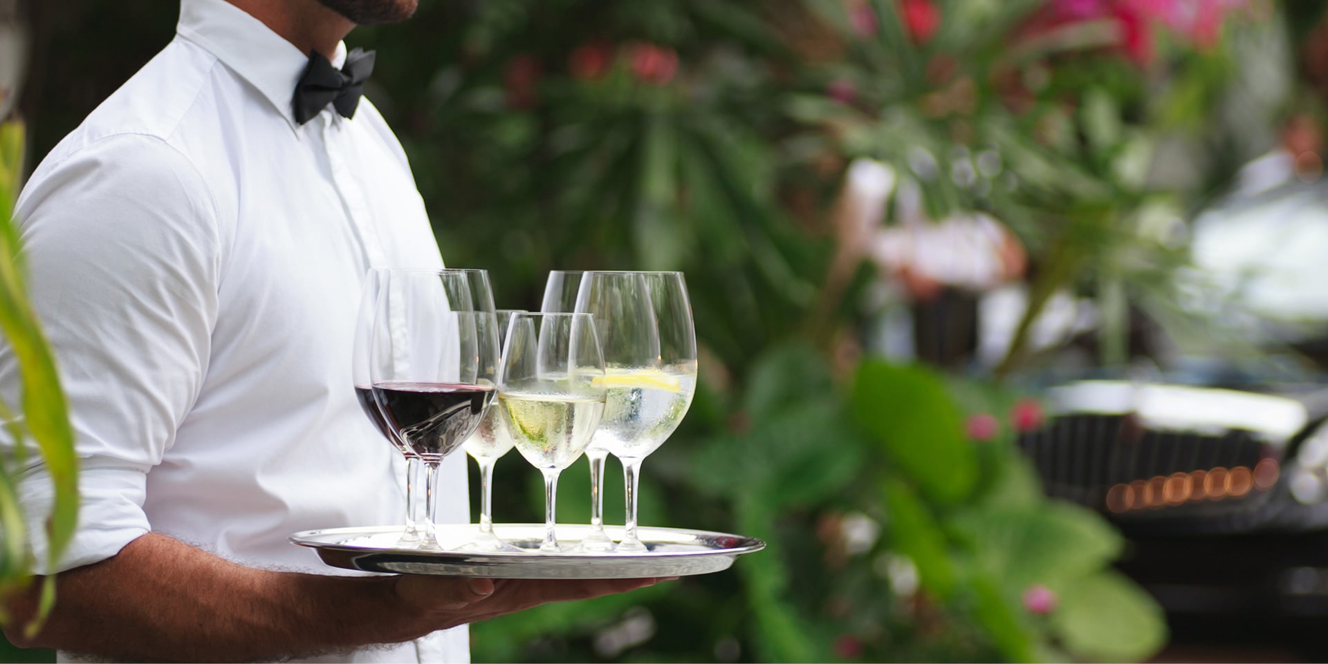 Drinks being served outside by a waiter at The Residences at The St. Regis Longboat Key