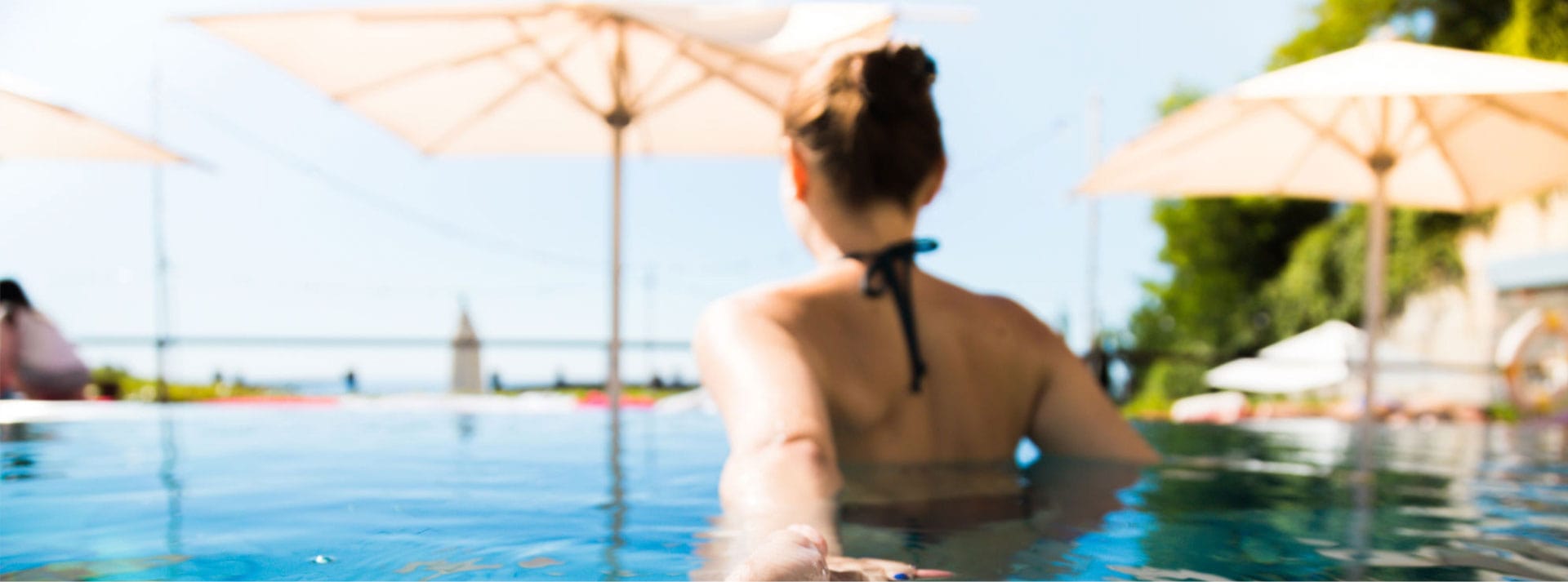 Woman in infinity pool at The Residences at The St. Regis Longboat Key