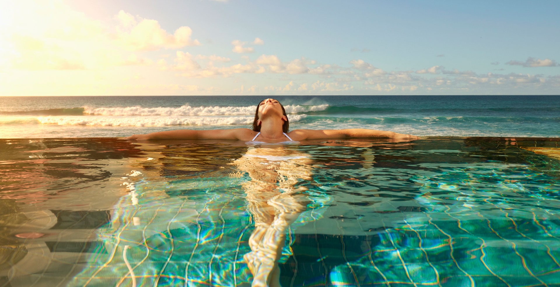 Woman relaxing in one of the infinity pools at The Residences at The St. Regis Longboat Key