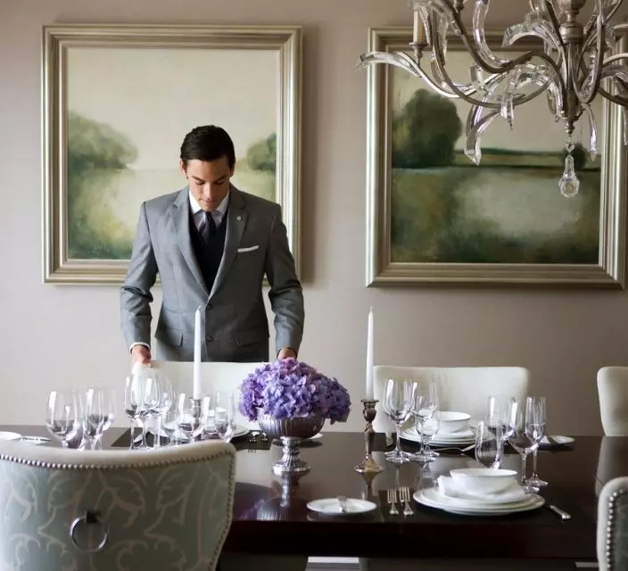 man setting table at The St Regis